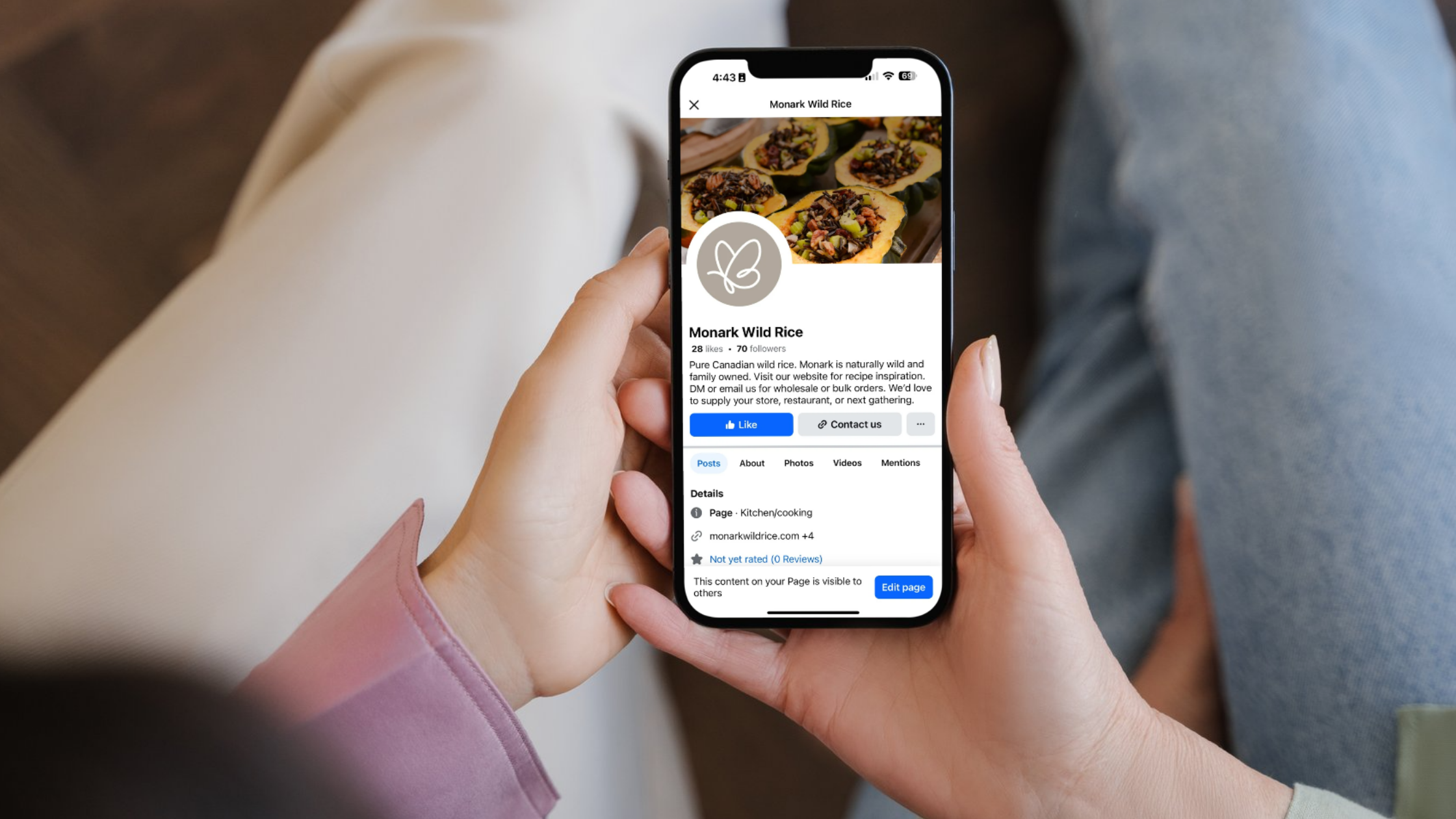 Monark Wild Rice Facebook Optimization A mobile phone displays Monark Wild Rice’s optimized Facebook page with a branded profile image, seasonal cover photo, contact buttons, and a clearly written bio.