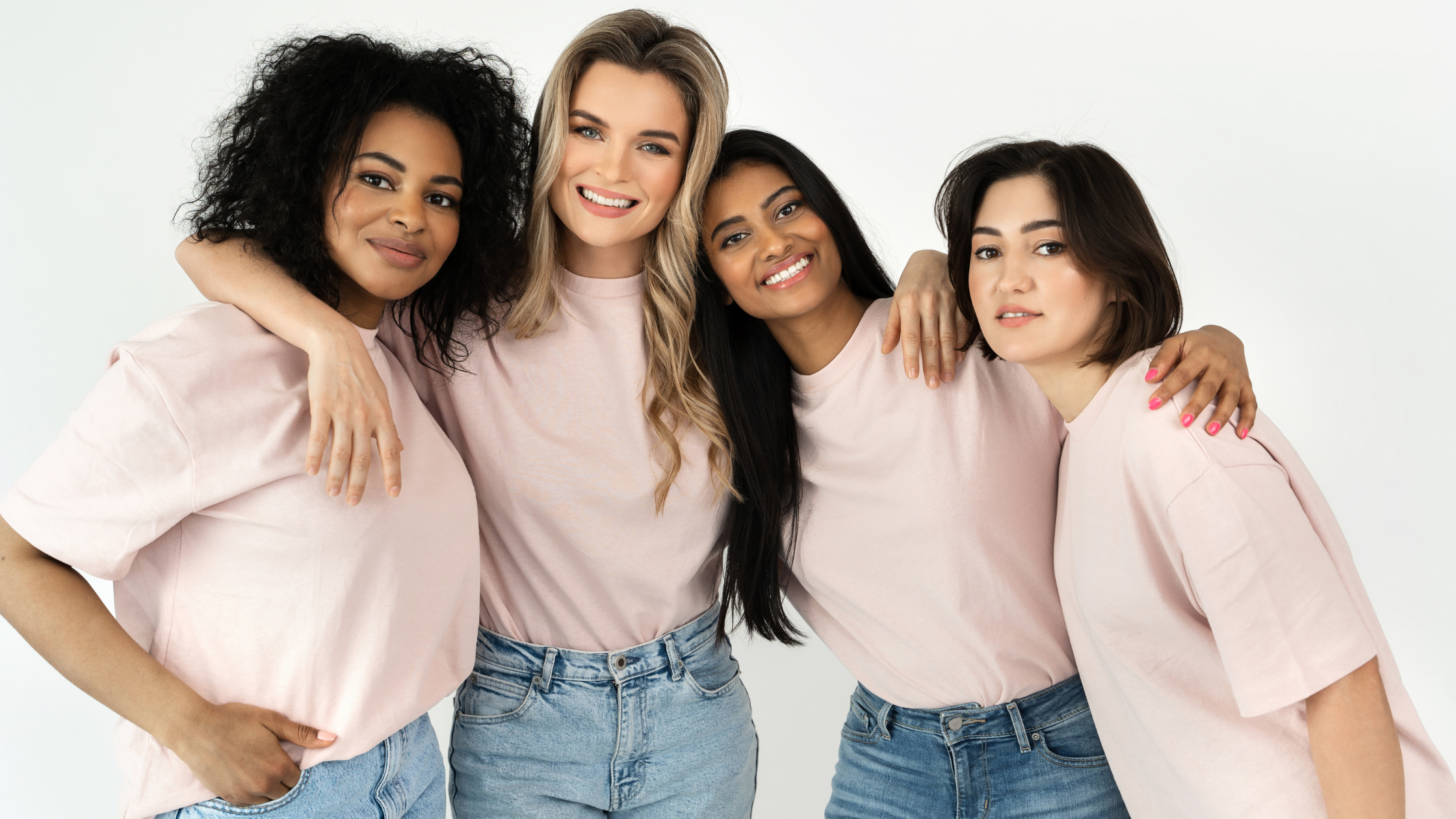 Real People, Real Strategy: Start With the Humans Behind Your Persona Four diverse women smiling and hugging in matching pink shirts, representing real-life community and authentic audience personas.