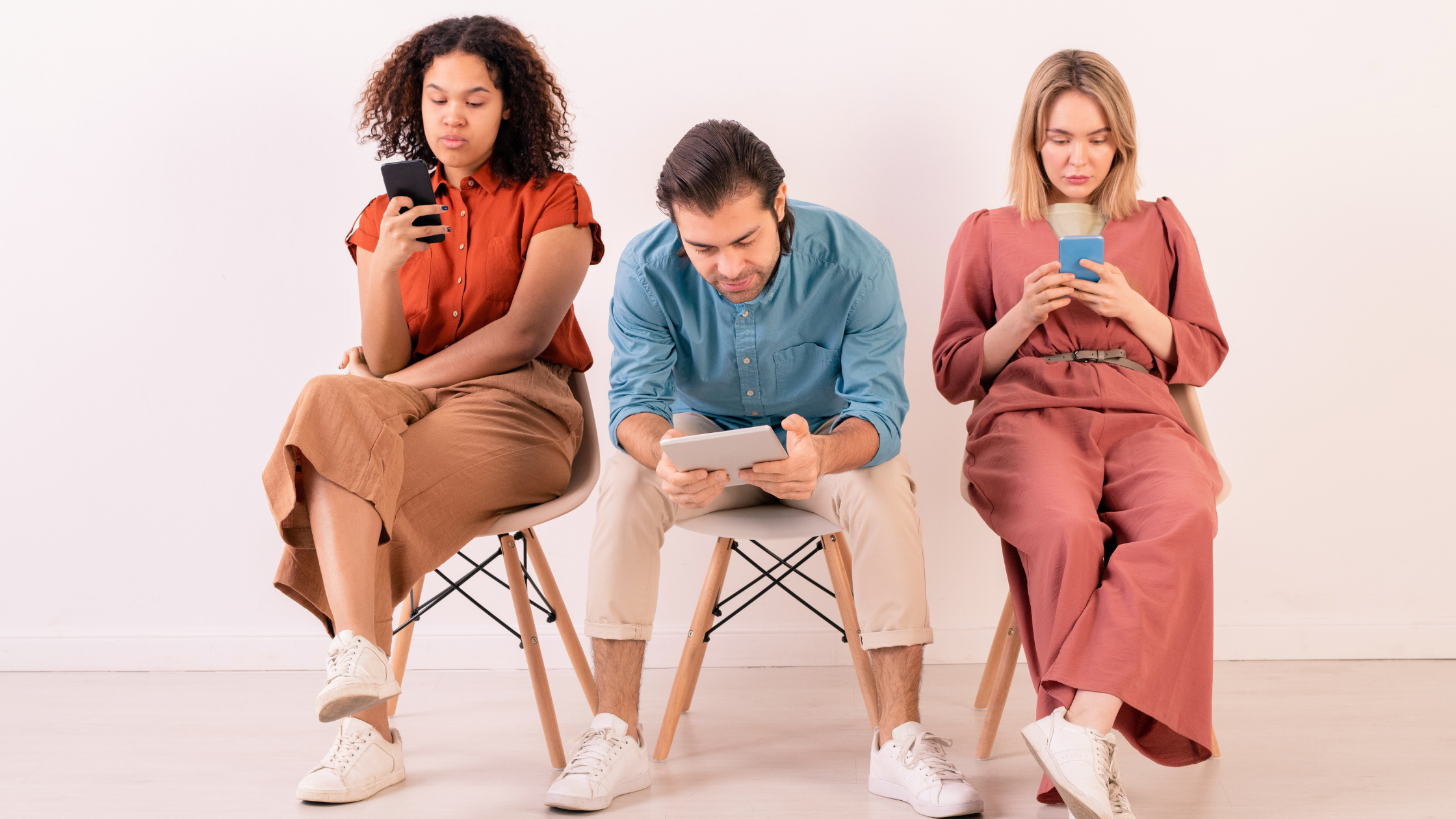 Your Audience Is Already Online—The Question Is: Do You Understand Them? Three people sitting and using phones and tablets, symbolizing different digital behavior patterns for social media audiences.