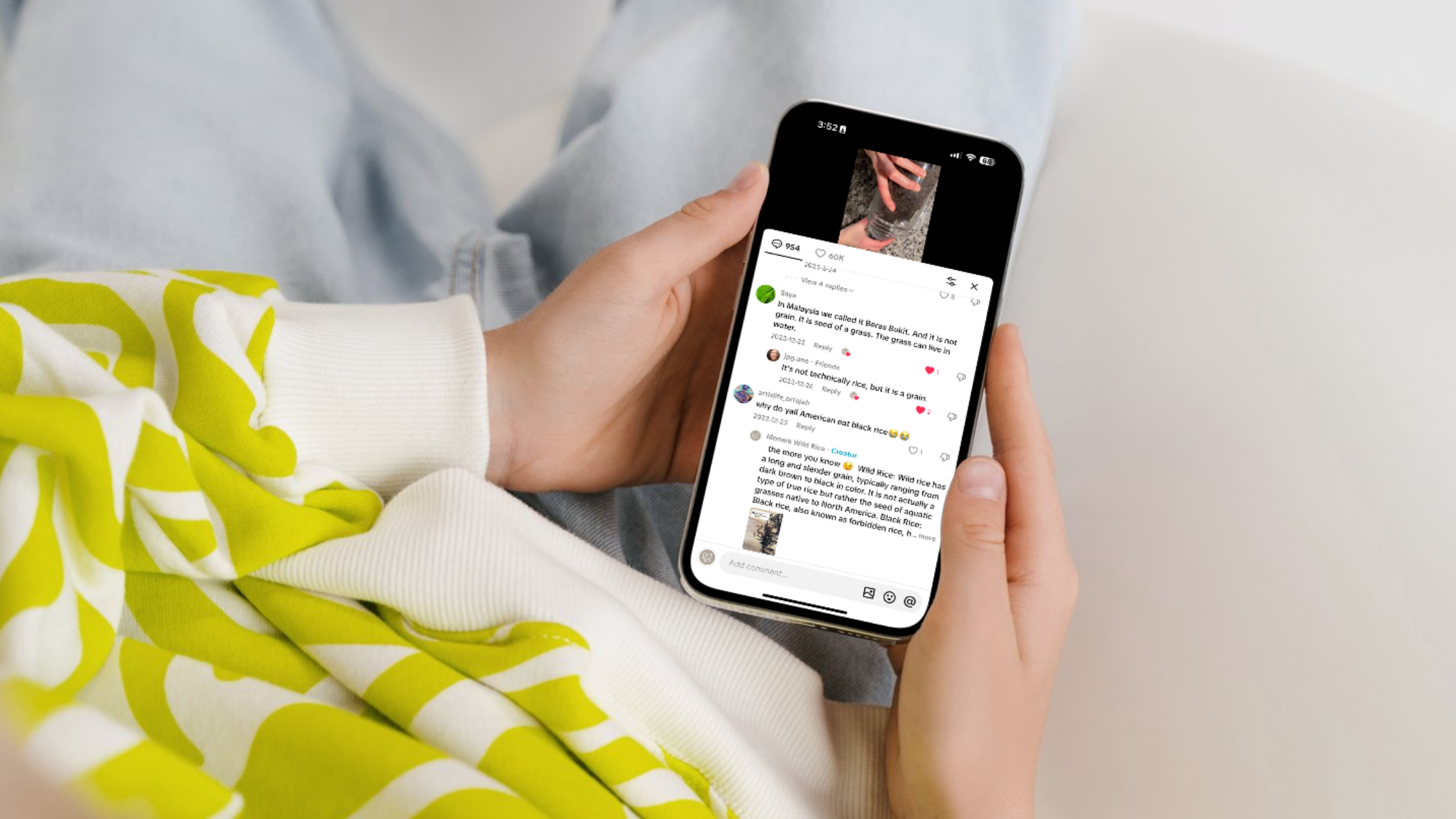 TikTok Wild Rice Comment Section with Audience Reactions Person holding a smartphone showing TikTok comments about wild rice, including cultural references and explanations.