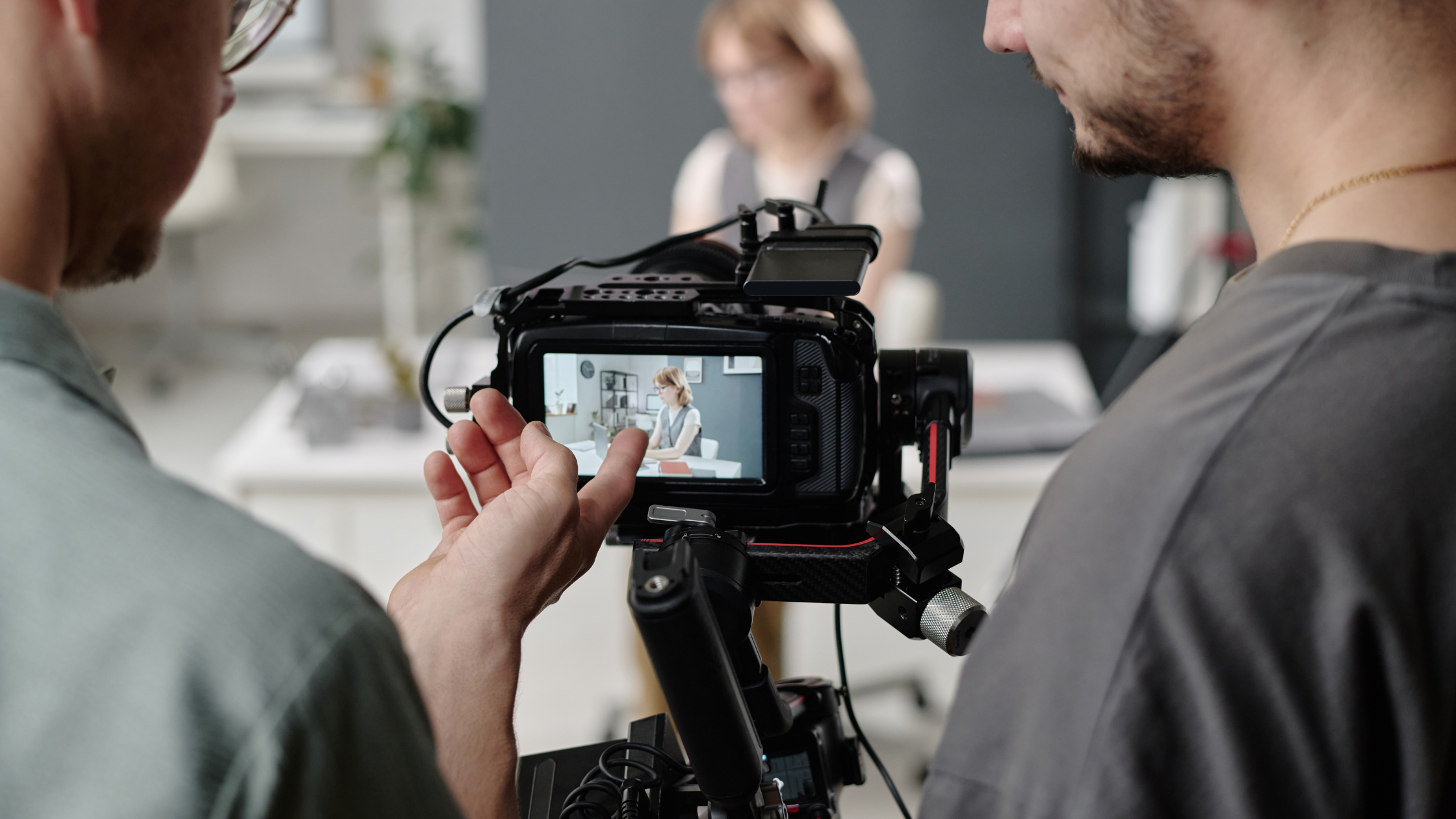 A video production team filming a professional on camera during a content shoot.