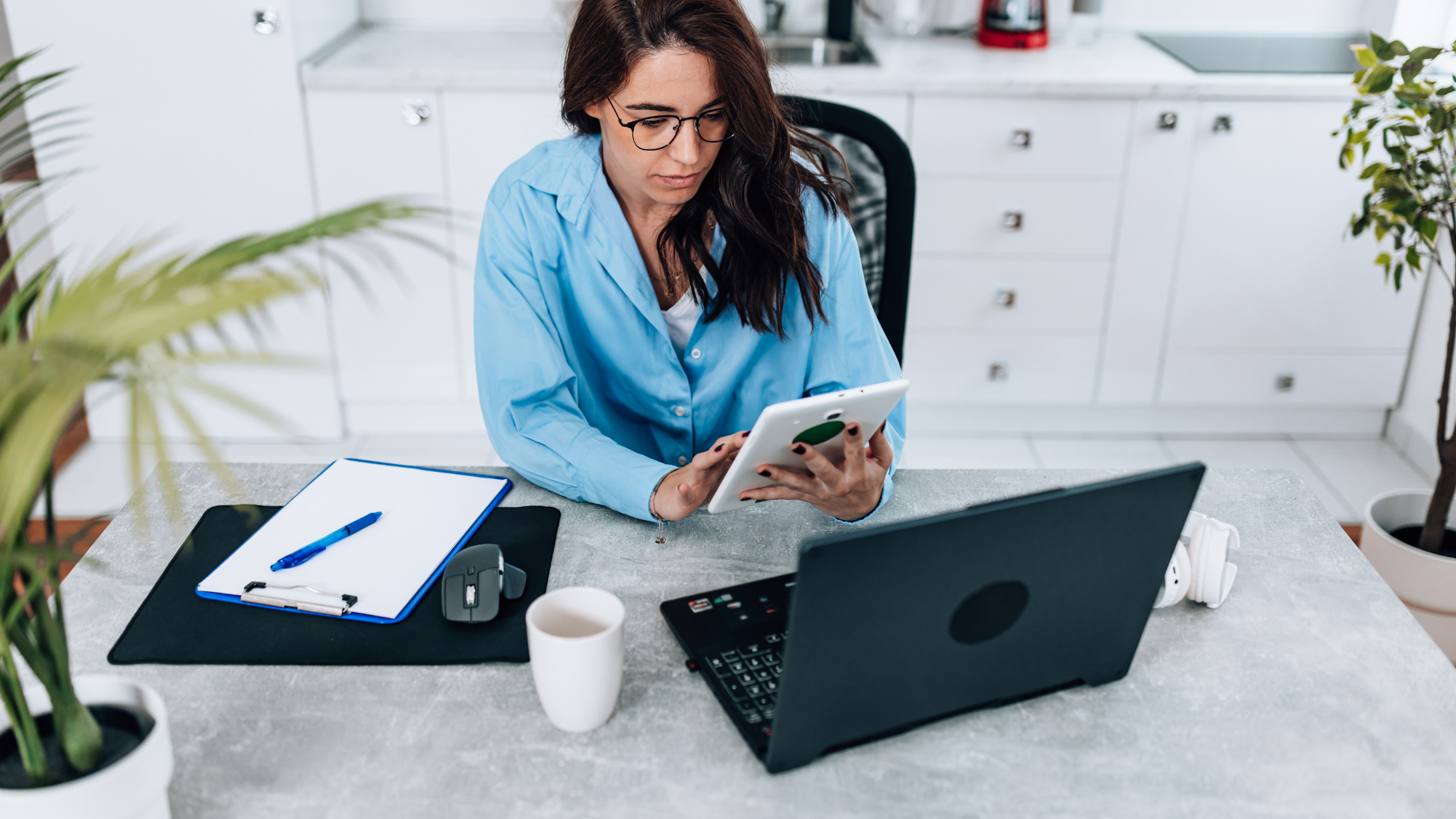 Business owner reviewing social media strategy and costs on a tablet at a modern desk