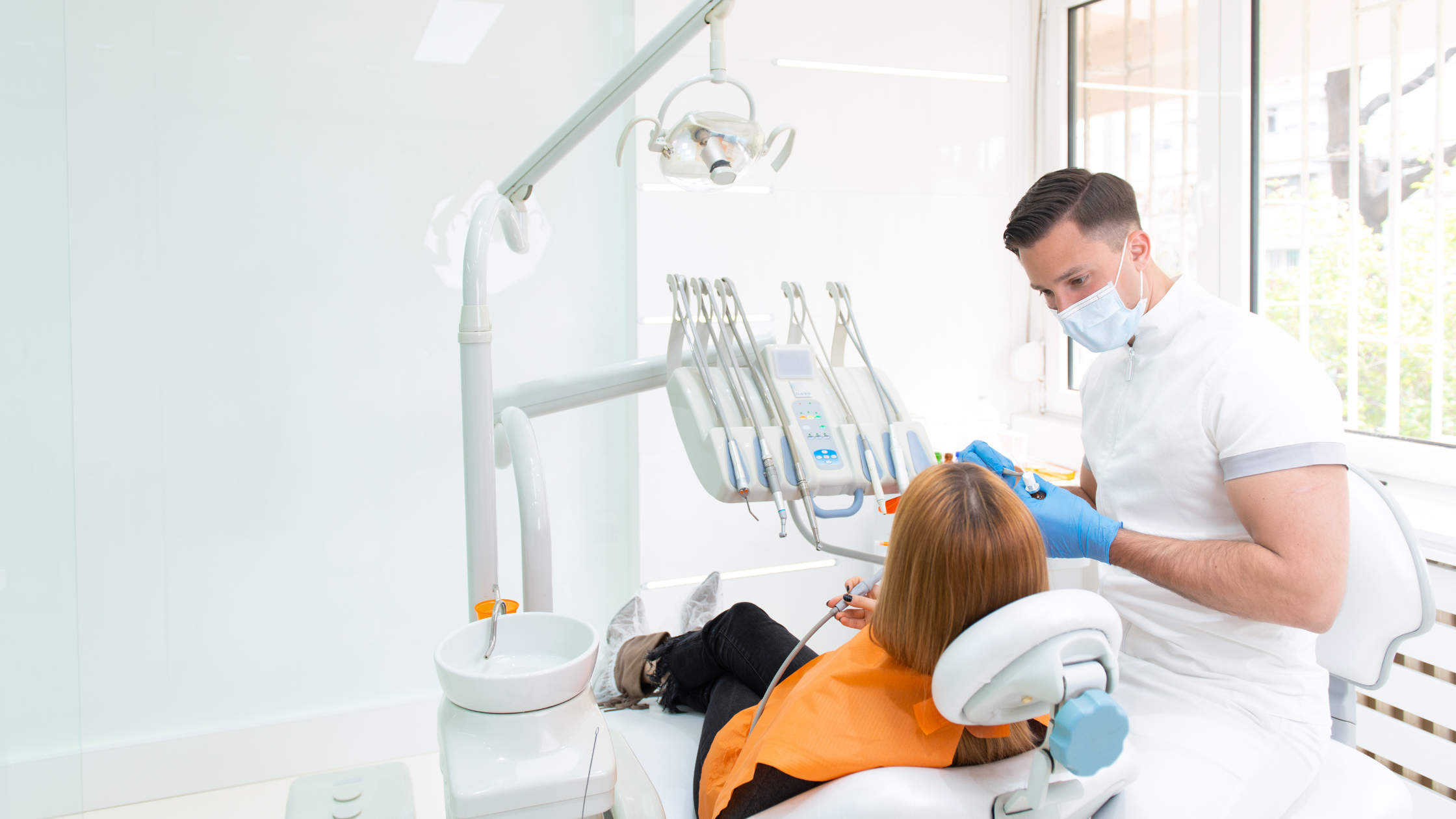 Dentist treating a patient in a modern dental clinic with advanced equipment