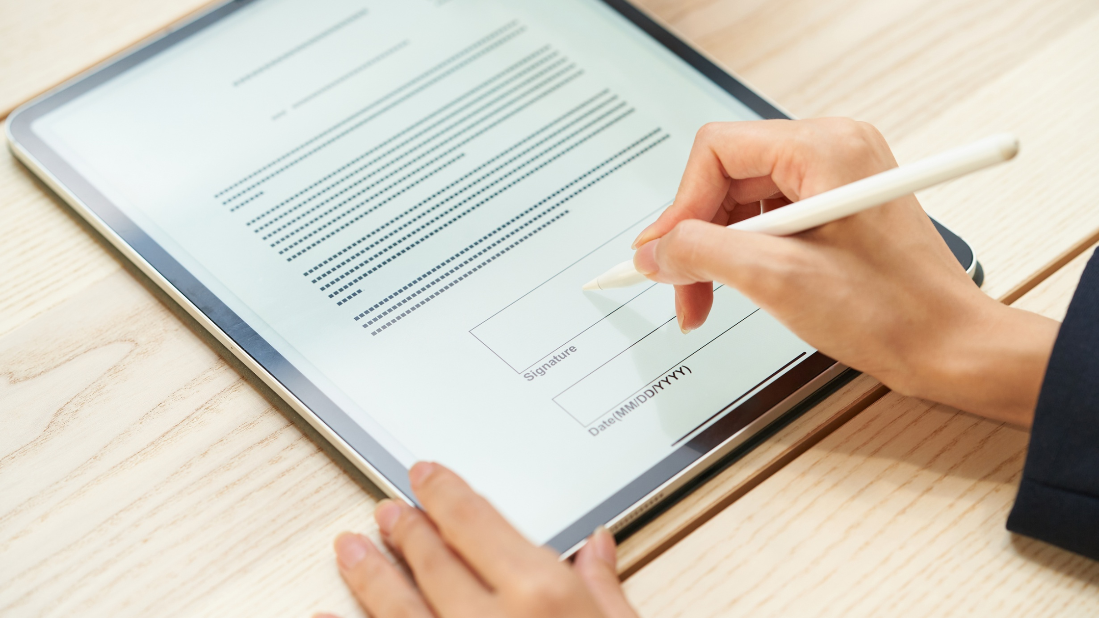 Brand manager signing a digital creator contract on a tablet for a product seeding collaboration