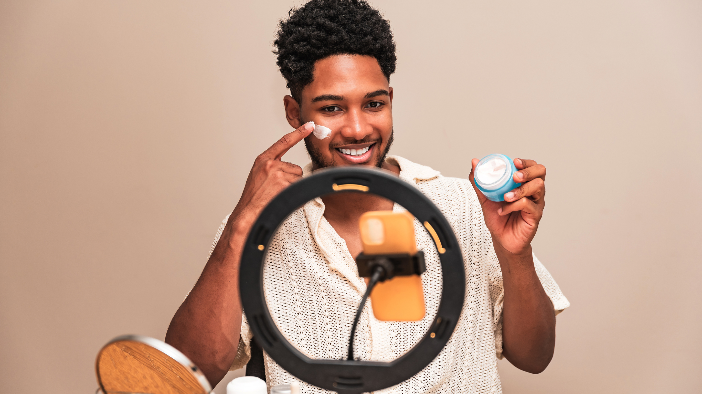 Male micro-influencer reviewing skincare product on camera during a product seeding collaboration