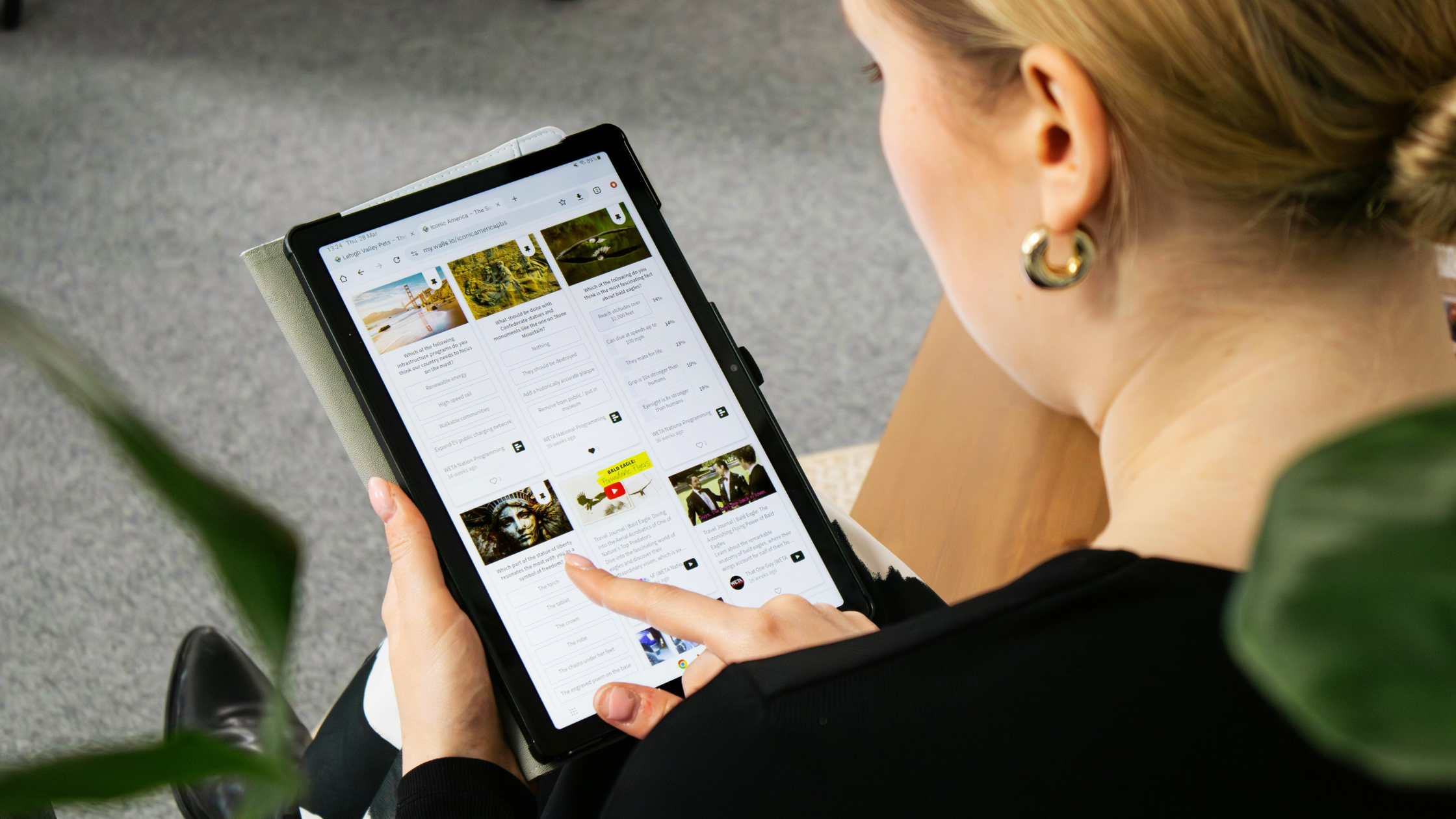 Woman browsing social media content feed on a tablet showing creator posts and influencer marketing content