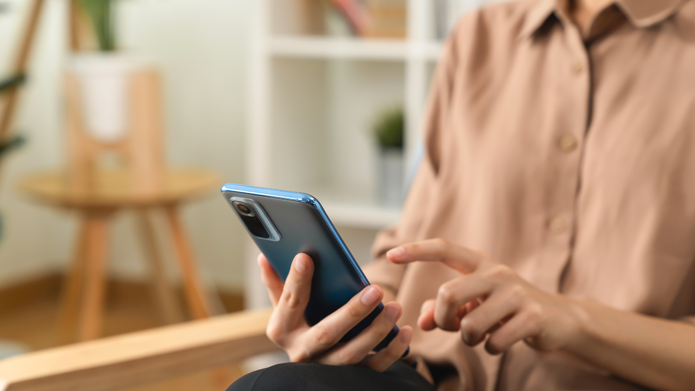Close up of hand scrolling on a smartphone to research content creators