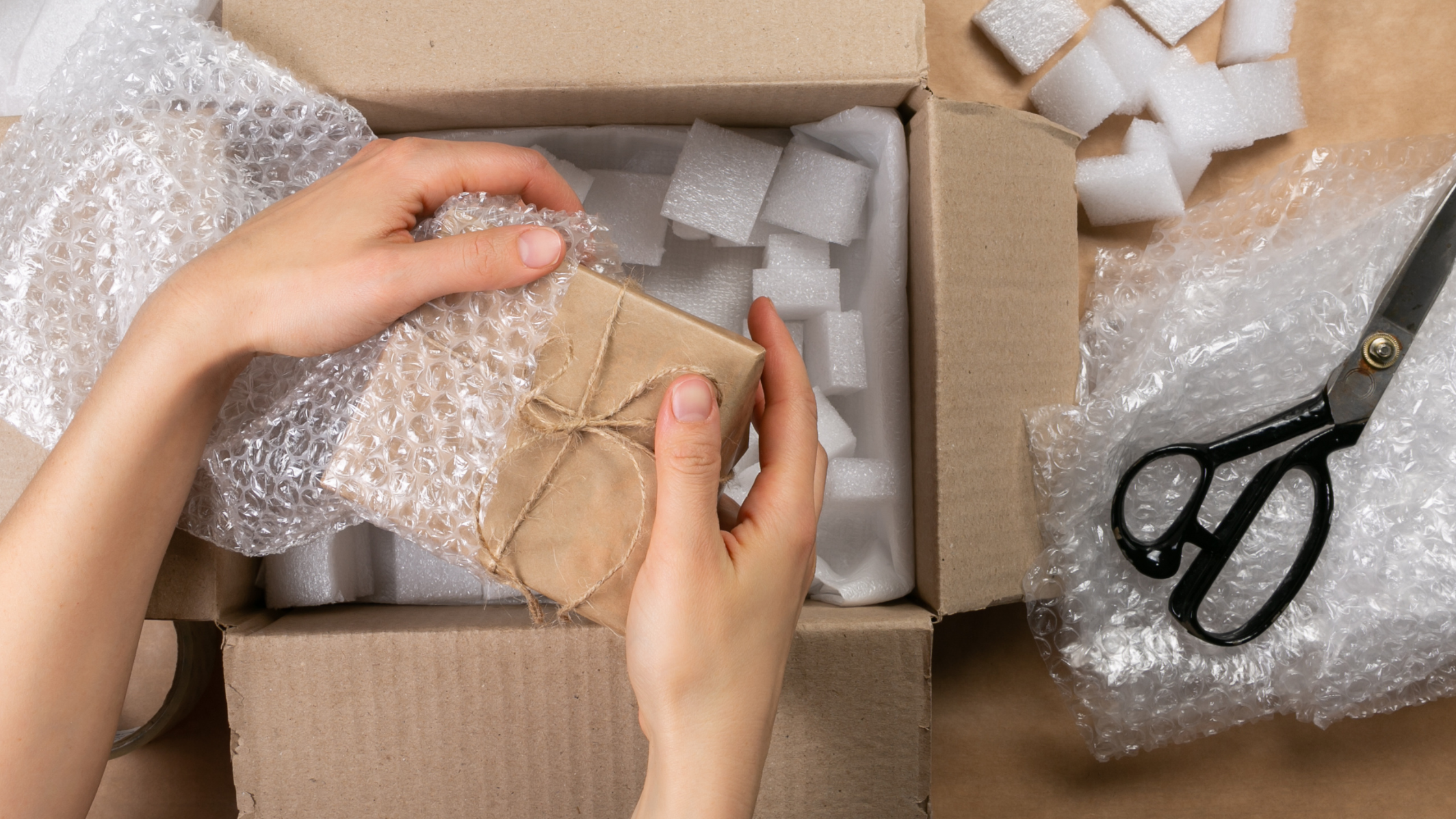 Hands unwrapping a seeded product package surrounded by bubble wrap