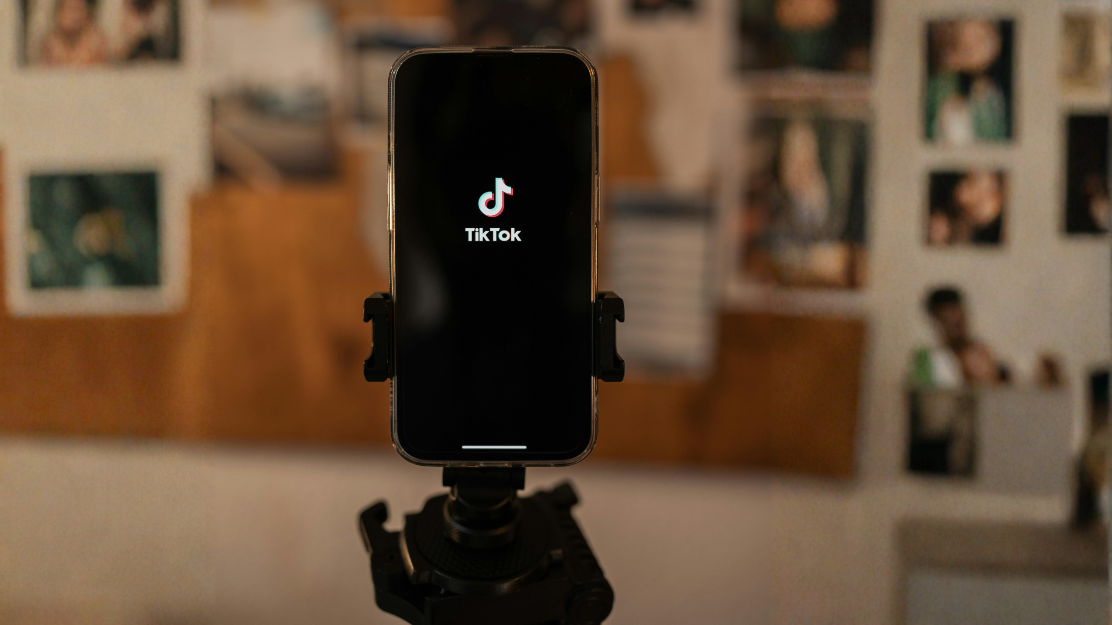 Smartphone on a tripod displaying the TikTok app, set up for creator content filming