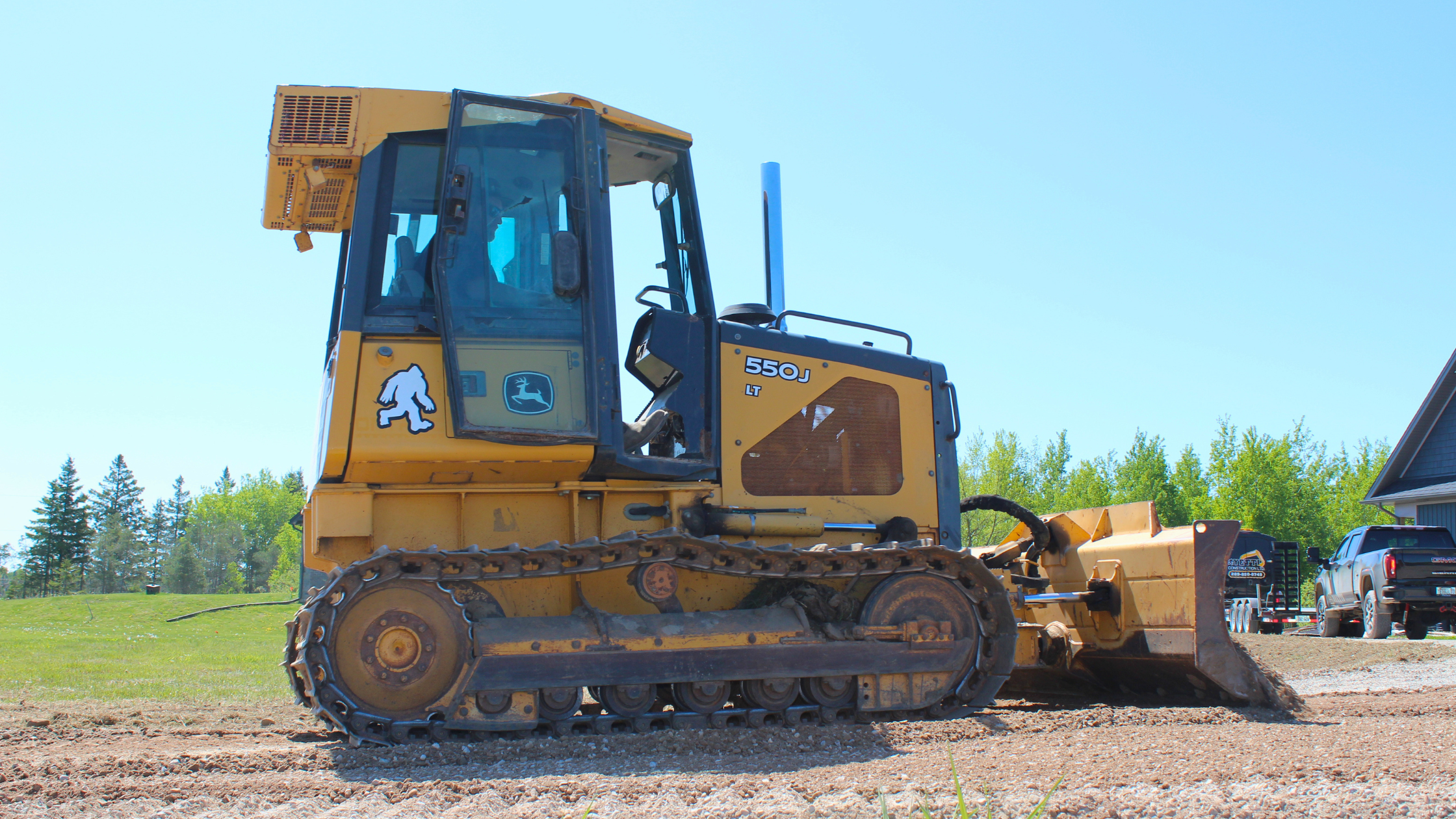 John Deere 550J LT dozer with Yetti Construction Sasquatch logo decal