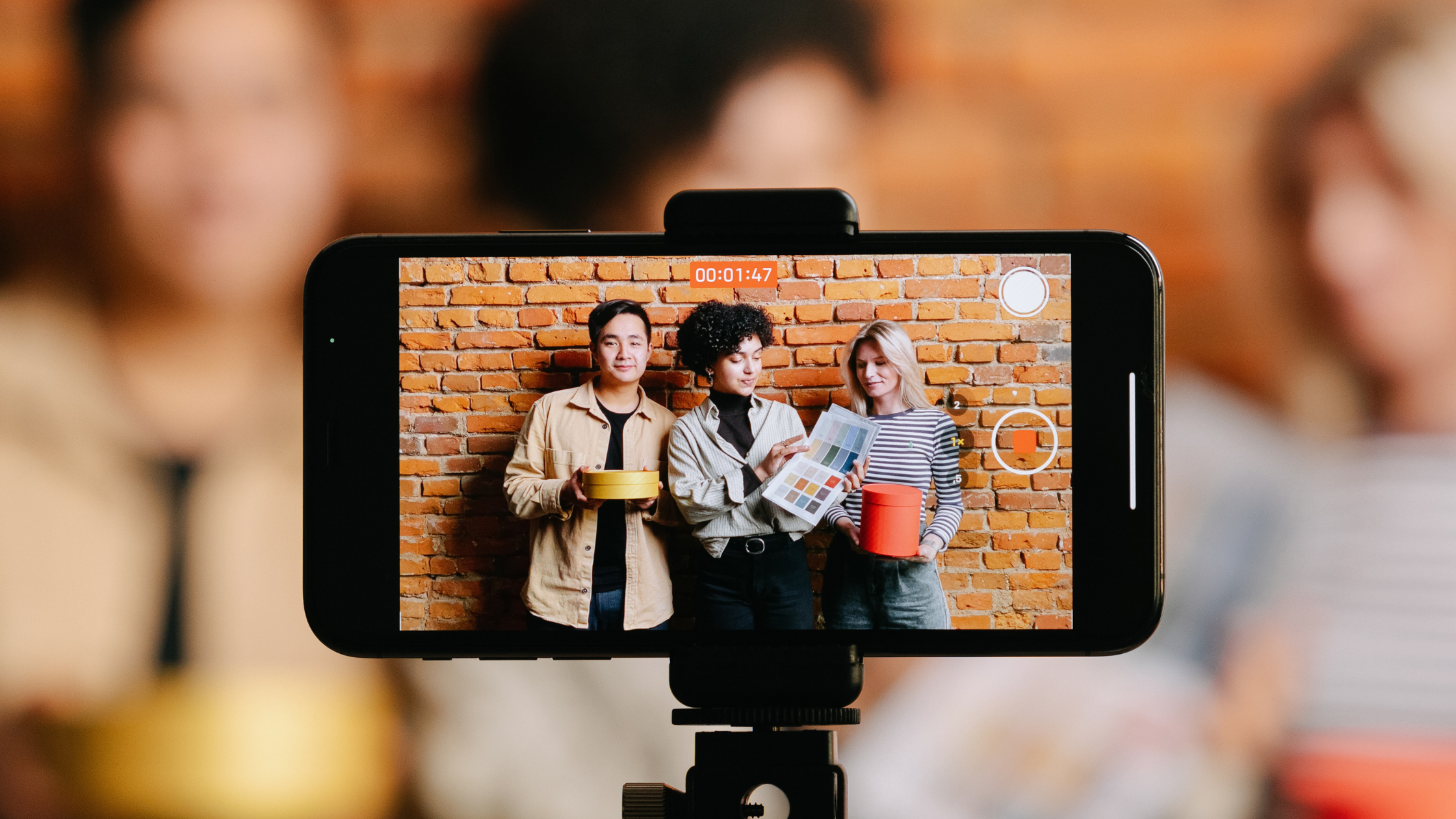 Content creators filming a product seeding video with colorful branded boxes
