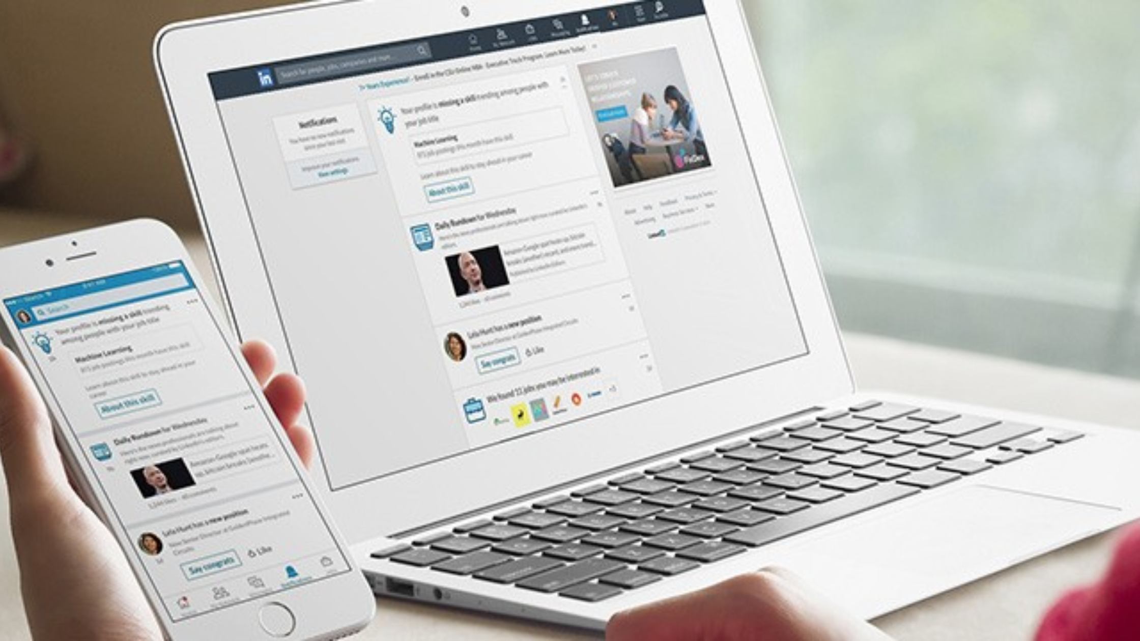 LinkedIn news feed and notifications open on both a laptop and a phone screen