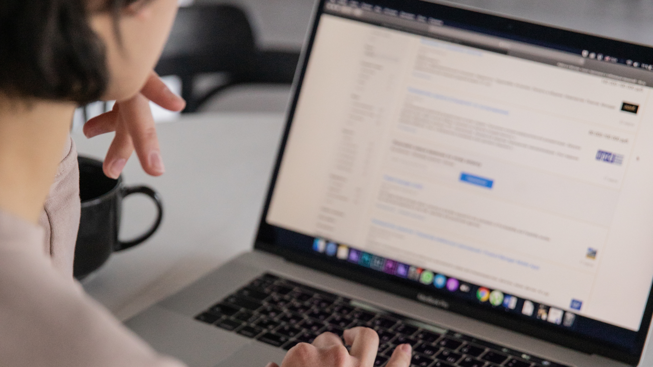 Person gesturing while looking at a laptop screen showing search results, representing generative engine optimization and AI search visibility
